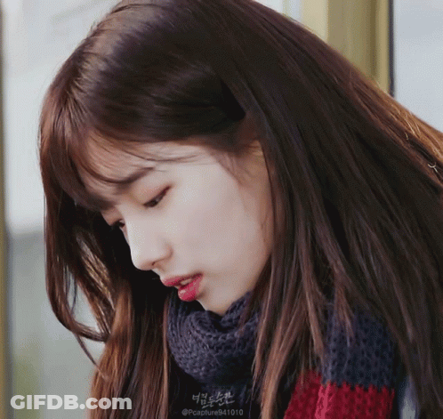 A Close Up Of A Woman 'S Face With A Scarf Around Her Neck That Says @Capture941010 GIF