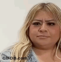 A Close Up Of A Woman 'S Face With A Serious Expression . GIF
