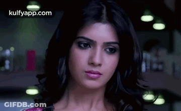 A Close Up Of A Woman 'S Face With A Serious Expression . GIF