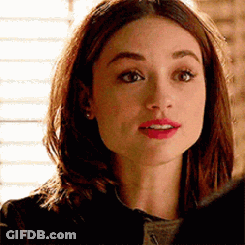 A Close Up Of A Woman 'S Face With A Serious Expression . GIF
