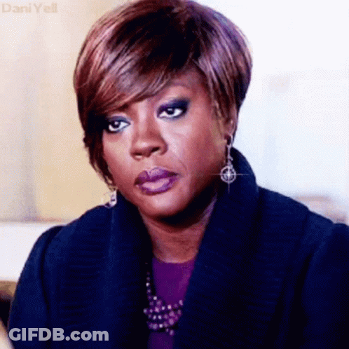 A Close Up Of A Woman 'S Face With A Serious Look On Her Face GIF