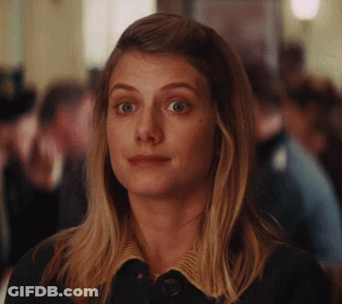 A Close Up Of A Woman 'S Face With A Serious Look On Her Face GIF