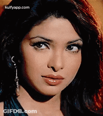 A Close Up Of A Woman 'S Face With A Serious Look On Her Face GIF