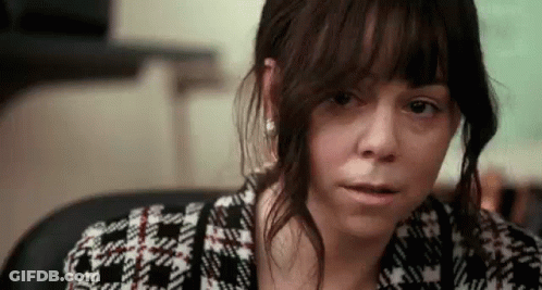 A Close Up Of A Woman 'S Face With A Serious Look On Her Face . GIF