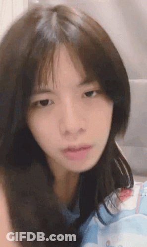 A Close Up Of A Woman 'S Face With A Serious Look On Her Face GIF