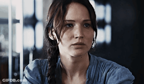 A Close Up Of A Woman 'S Face With A Serious Look On Her Face GIF