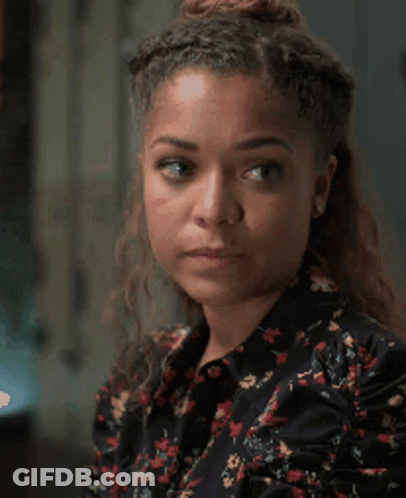 A Close Up Of A Woman 'S Face With A Serious Look On Her Face GIF
