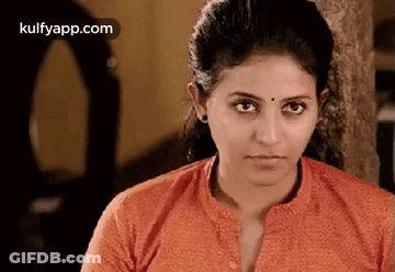 A Close Up Of A Woman 'S Face With A Serious Look On Her Face . GIF