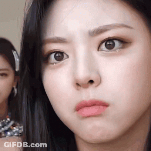 A Close Up Of A Woman 'S Face With A Serious Look On Her Face . GIF