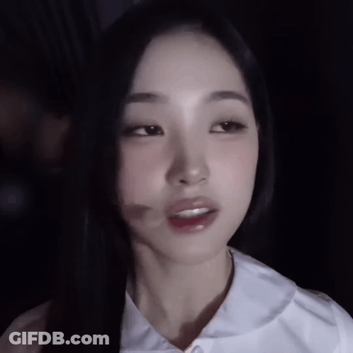 A Close Up Of A Woman 'S Face With A Shadow On Her Face GIF