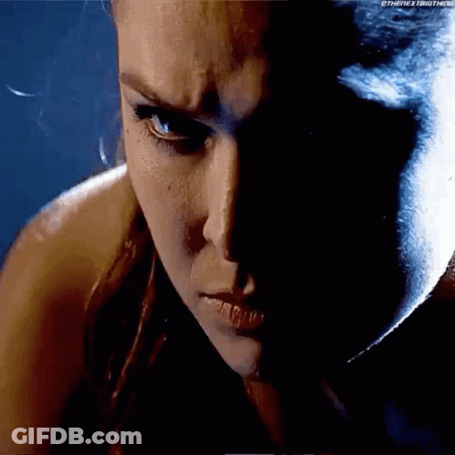 A Close Up Of A Woman 'S Face With A Shadow On It . GIF