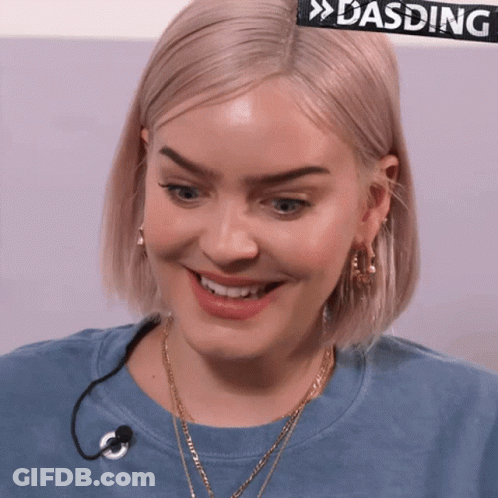 A Close Up Of A Woman 'S Face With A Sign That Says Dasding Behind Her GIF