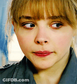 A Close Up Of A Woman 'S Face With A Slight Smile On Her Face GIF