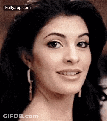 A Close Up Of A Woman 'S Face With A Slight Smile On Her Face . GIF