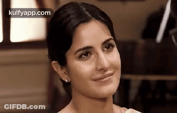 A Close Up Of A Woman 'S Face With A Slight Smile On Her Face . GIF