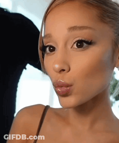 A Close Up Of A Woman 'S Face With A Slight Smile On Her Face GIF