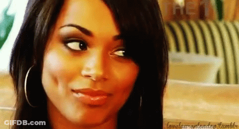 A Close Up Of A Woman 'S Face With A Slight Smile On Her Face . GIF