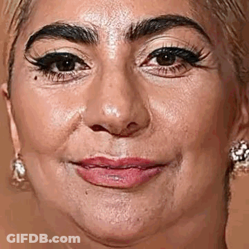 A Close Up Of A Woman 'S Face With A Slight Smile On It . GIF
