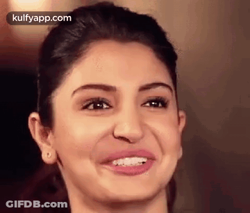 A Close Up Of A Woman 'S Face With A Smile . GIF