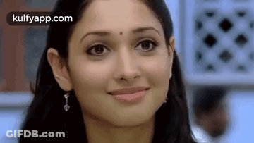 A Close Up Of A Woman 'S Face With A Smile . GIF