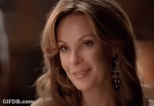 A Close Up Of A Woman 'S Face With A Smile On Her Face . GIF