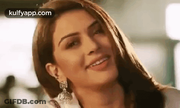 A Close Up Of A Woman 'S Face With A Smile On Her Face . GIF
