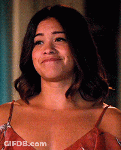 A Close Up Of A Woman 'S Face With A Smile On Her Face . GIF