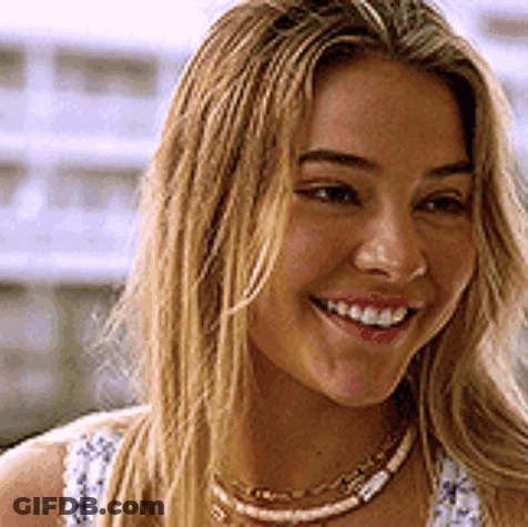 A Close Up Of A Woman 'S Face With A Smile On Her Face . GIF