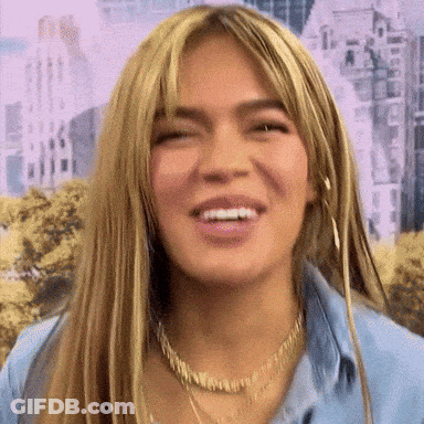 A Close Up Of A Woman 'S Face With A Smile On Her Face . GIF