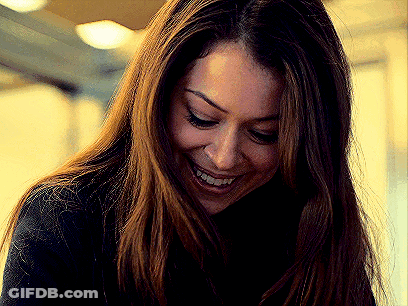 A Close Up Of A Woman 'S Face With A Smile On Her Face . GIF