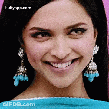 A Close Up Of A Woman 'S Face With A Smile On Her Face . GIF