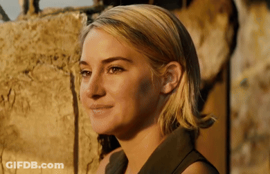 A Close Up Of A Woman 'S Face With A Smile On Her Face . GIF