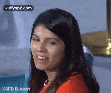 A Close Up Of A Woman 'S Face With A Smile On Her Face . GIF