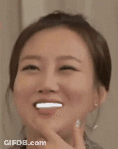 A Close Up Of A Woman 'S Face With A Smile On Her Face . GIF