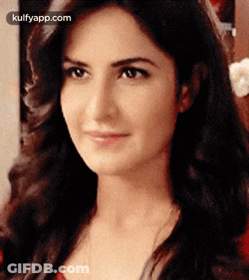 A Close Up Of A Woman 'S Face With A Smile On Her Face GIF