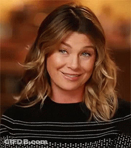 A Close Up Of A Woman 'S Face With A Smile On Her Face . GIF