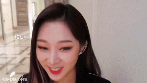 A Close Up Of A Woman 'S Face With A Smile On Her Face GIF