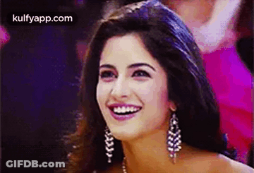A Close Up Of A Woman 'S Face With A Smile On Her Face . GIF