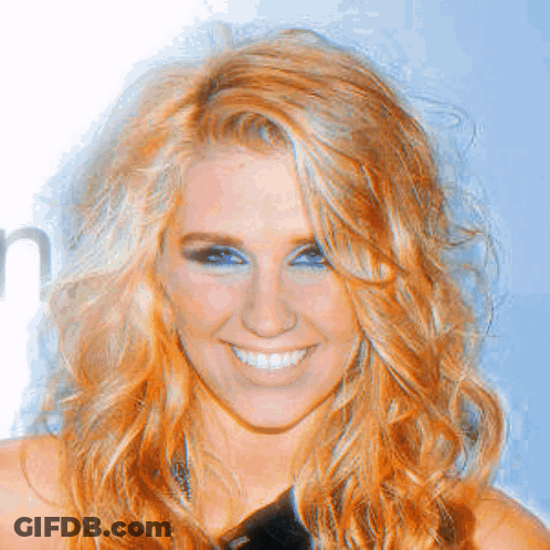 A Close Up Of A Woman 'S Face With A Smile On Her Face GIF