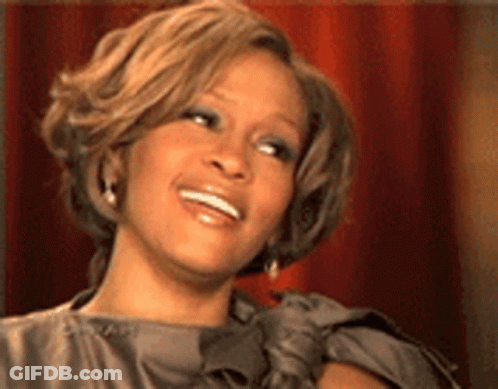A Close Up Of A Woman 'S Face With A Smile On Her Face . GIF
