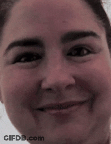 A Close Up Of A Woman 'S Face With A Smile On It GIF