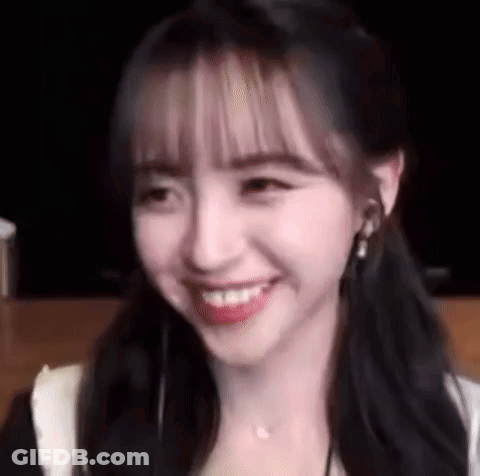 A Close Up Of A Woman 'S Face With A Smile On It . GIF