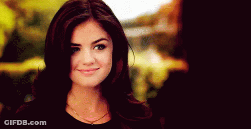 A Close Up Of A Woman 'S Face With A Smile On It . GIF