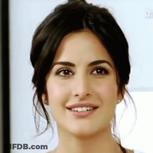 A Close Up Of A Woman 'S Face With A Smiling Expression . GIF