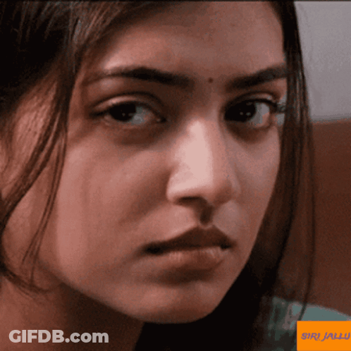 A Close Up Of A Woman 'S Face With A Sticker That Says ' Wiki Malayalam ' On It GIF