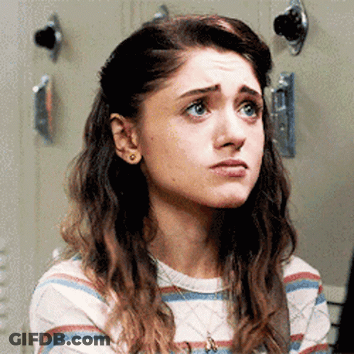 A Close Up Of A Woman 'S Face With A Striped Shirt And A Necklace . GIF