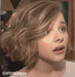 A Close Up Of A Woman 'S Face With A Surprised Expression On Her Face . GIF
