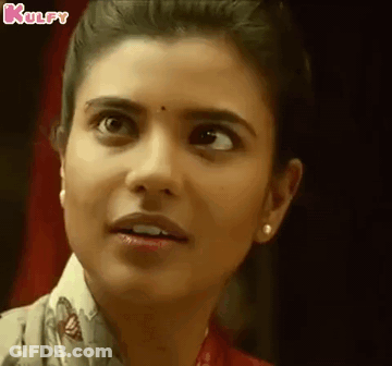 A Close Up Of A Woman 'S Face With A Surprised Expression On Her Face . GIF