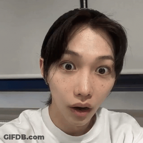 A Close Up Of A Woman 'S Face With A Surprised Look On Her Face GIF