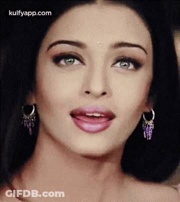 A Close Up Of A Woman 'S Face With A Surprised Look On Her Face . GIF
